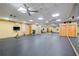 Bright fitness room with ceiling fans, full mirrors, and wood doors leading to bathrooms or locker rooms at 400 17Th Nw St # 2120, Atlanta, GA 30363