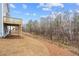 Backyard featuring new construction, wood deck, freshly seeded yard, and wooded background at 109 Laurelwood Ln, Dallas, GA 30157