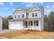 Beautiful two-story home with a gray exterior, white trim, and a spacious two-car garage at 109 Laurelwood Ln, Dallas, GA 30157