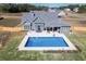 Aerial view of a backyard pool and patio area, showcasing the property and outdoor space at 255 Old Town Rd, Dacula, GA 30019