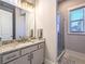 Bright bathroom features a granite-topped vanity and a glass-enclosed shower with natural light at 255 Old Town Rd, Dacula, GA 30019