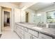 Elegant bathroom featuring double sinks, granite countertops, and a large mirror with modern lighting at 255 Old Town Rd, Dacula, GA 30019