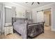 Cozy bedroom featuring a decorative wrought iron bed, soft lighting, and an ensuite bathroom at 255 Old Town Rd, Dacula, GA 30019
