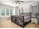 Spacious bedroom with a decorative iron bed frame, neutral color scheme, and plenty of natural light at 255 Old Town Rd, Dacula, GA 30019
