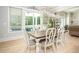 Dining room featuring a rustic wooden table, white chairs, and a view of the backyard pool at 255 Old Town Rd, Dacula, GA 30019