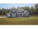 Beautiful two-story home featuring a well-manicured lawn, a blue exterior, and a charming front porch at 255 Old Town Rd, Dacula, GA 30019