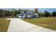 Desirable curb appeal with long driveway leading up to a two-story home and attached three car garage at 255 Old Town Rd, Dacula, GA 30019