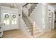 Welcoming foyer features a staircase, glass front door, and beautiful hardwood flooring at 255 Old Town Rd, Dacula, GA 30019