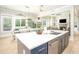 Open concept kitchen with large island, stainless steel dishwasher, and view into the living room and dining area at 255 Old Town Rd, Dacula, GA 30019