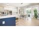 Modern kitchen features white cabinets, quartz countertops, stainless steel appliances, and a dining area at 255 Old Town Rd, Dacula, GA 30019