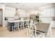 Bright kitchen featuring white cabinets, stainless steel appliances, a large island, and an adjacent dining area at 255 Old Town Rd, Dacula, GA 30019