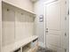 Well-organized mudroom with bench, storage, hooks, and a convenient side entrance at 255 Old Town Rd, Dacula, GA 30019