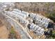Aerial view of townhouses, Lot 45 highlighted, near a road and wooded area at 1788 Peach Blossom Ne Ln # 45, Atlanta, GA 30324