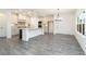 Bright kitchen featuring gray wood floors, white cabinets, a large island and stainless steel appliances at 1176 Red Oak Blvd, Loganville, GA 30052