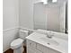 Clean bathroom with white vanity, toilet, and decorative mirror at 200 Eagle Glen Ct, Woodstock, GA 30189