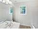 Bright bathroom featuring large mirror, double vanity, and shower-tub combo at 200 Eagle Glen Ct, Woodstock, GA 30189