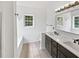 Bright bathroom featuring double sink vanity, modern fixtures, and separate tub and shower at 200 Eagle Glen Ct, Woodstock, GA 30189