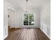 Bright dining room with a stylish chandelier, modern floors, and large windows at 200 Eagle Glen Ct, Woodstock, GA 30189