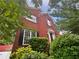 Charming brick home featuring black shutters, surrounded by lush greenery and mature trees at 200 Eagle Glen Ct, Woodstock, GA 30189