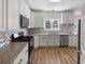 Modern kitchen with stainless steel appliances, granite counters, tile backsplash, and custom cabinetry at 200 Eagle Glen Ct, Woodstock, GA 30189