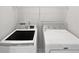 Well-equipped laundry area featuring modern washer and dryer with overhead shelving at 200 Eagle Glen Ct, Woodstock, GA 30189