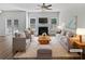 Bright living room with fireplace, ceiling fan, modern furniture, and french doors to the outside at 200 Eagle Glen Ct, Woodstock, GA 30189