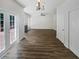 Spacious living room with modern floors, fireplace, and access to outdoor deck at 200 Eagle Glen Ct, Woodstock, GA 30189