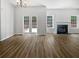 Bright living room featuring fireplace and french doors at 200 Eagle Glen Ct, Woodstock, GA 30189