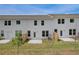 Backyard view of townhome featuring a small patio and green grass at 212 Sanctuary Drive, Mcdonough, GA 30253