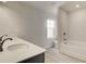 Bright bathroom featuring a modern vanity, white tile floors, and bathtub at 212 Sanctuary Drive, Mcdonough, GA 30253