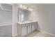 Bathroom with a double vanity featuring a large mirror and plenty of cabinet storage at 212 Sanctuary Drive, Mcdonough, GA 30253
