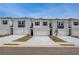 Charming townhomes featuring brick, white siding, garages, and well-manicured landscaping at 212 Sanctuary Drive, Mcdonough, GA 30253