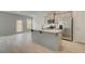 Eat-in kitchen island featuring stainless steel appliances, gray cabinets, and bright natural light at 212 Sanctuary Drive, Mcdonough, GA 30253