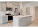 Modern kitchen features stainless steel appliances, white countertops and backsplash with a kitchen island at 212 Sanctuary Drive, Mcdonough, GA 30253