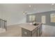 Spacious open-concept living area featuring an island with sink and stainless steel appliances at 212 Sanctuary Drive, Mcdonough, GA 30253