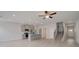 Open concept living room with gray walls, light wood floors, and eat-in kitchen island at 212 Sanctuary Drive, Mcdonough, GA 30253