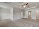 Spacious main bedroom with a trey ceiling, carpeted floor, ceiling fan, and neutral color walls at 212 Sanctuary Drive, Mcdonough, GA 30253