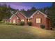 Brick home with landscaping, at dusk at 512 Clearwater Dr, Mcdonough, GA 30252