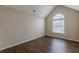 Spacious bedroom with vaulted ceiling, modern flooring, and a large arched window with natural light at 325 Welsh Ct, Fairburn, GA 30213