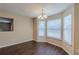 Sunlit dining area with three windows and traditional chandelier at 325 Welsh Ct, Fairburn, GA 30213