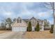 Traditional two-story home with a well-maintained lawn and a convenient two-car garage at 325 Welsh Ct, Fairburn, GA 30213