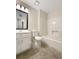 A bathroom with white fixtures, neutral walls, and tile floors at 5394 Muirwood Pl, Powder Springs, GA 30127