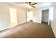 Open bedroom with ceiling fan features bathroom and closet entrances at 5394 Muirwood Pl, Powder Springs, GA 30127