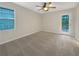 Well-lit bedroom with a door to the backyard and large window at 5394 Muirwood Pl, Powder Springs, GA 30127