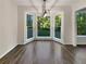 Dining room with a bay window, hardwood floors, and decorative lighting at 5394 Muirwood Pl, Powder Springs, GA 30127