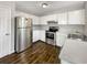 Kitchen featuring stainless steel appliances, white cabinets, and tile backsplash at 5394 Muirwood Pl, Powder Springs, GA 30127