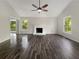 Bright living room boasts hardwood floors and a white painted fireplace at 5394 Muirwood Pl, Powder Springs, GA 30127
