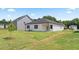 Well maintained backyard features a green lawn and a view of the home's exterior, perfect for outdoor enjoyment at 130 Oakchase Park Ln, Hampton, GA 30228
