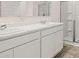 Bathroom with double sink vanity, white cabinets, and tiled walk-in shower at 130 Oakchase Park Ln, Hampton, GA 30228