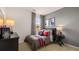 A modern bedroom features checkered accents, racing decor, comfortable bed, and a well-lit bedside table at 130 Oakchase Park Ln, Hampton, GA 30228
